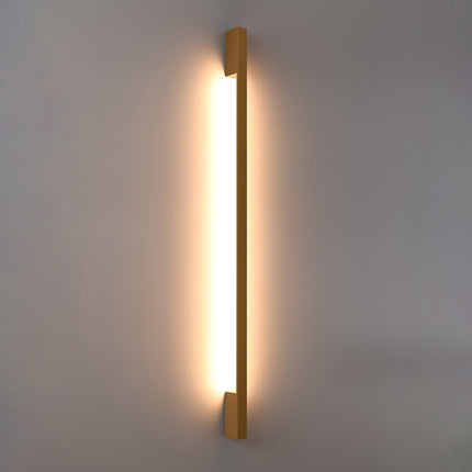 Applique Barre Contemporaine dorée allumée, halo blanc chaud diffusé le long du mur