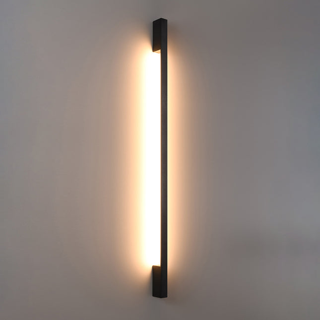 Applique Barre Contemporaine noire allumée, halo blanc chaud diffusé le long du mur