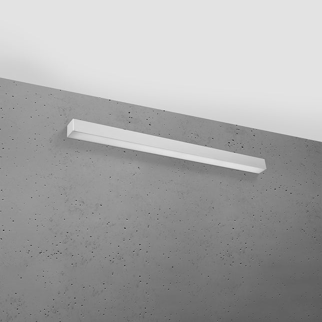 Applique barre moderne LED grise 90 cm installée sur un mur de béton