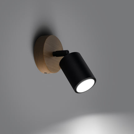 Gros plan sur le bras orientable en acier noir fixé au socle en bois naturel
