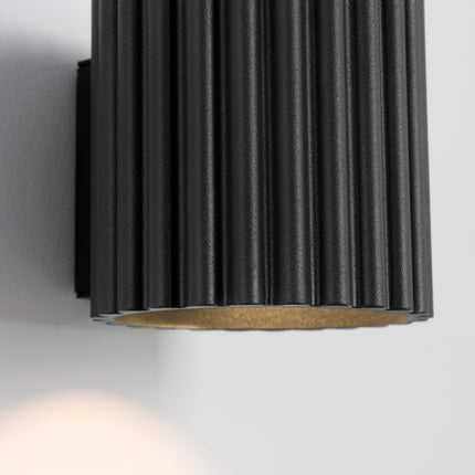 Gros plan sur les cannelures de l'applique Aura noire et son faisceau dirigé vers le bas