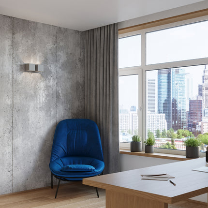 Applique Cube LED 2 feux installée sur un mur en béton dans un salon contemporain