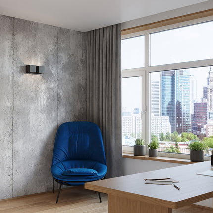 Applique Cube LED 2 feux installée sur un mur en béton dans un salon contemporain