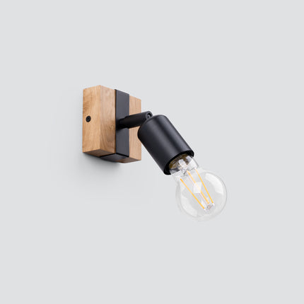 Applique orientable Élégance Bois Noir vue de côté, tête en métal noir inclinable sur socle en bois