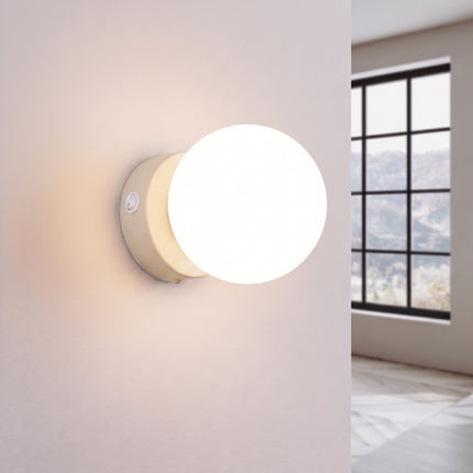 Applique Globe Solis beige allumée, halo doux du verre opalin