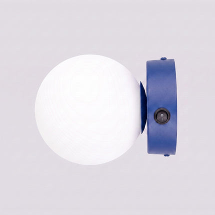 Applique Globe Solis bleu outremer sur fond coloré, vue de trois quarts