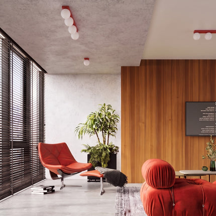 Applique Globe Solis rouge dans un salon lumineux aux boiseries claires
