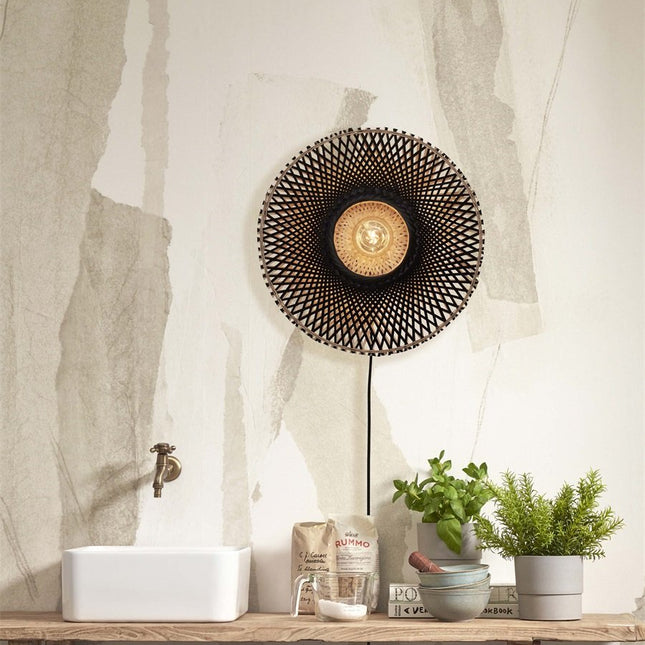 Kalimantan woven bamboo wall light above a vanity top, star pattern lit