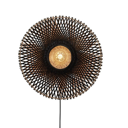 Front view of the Kalimantan wall light on, black and natural braided bamboo disc on white background