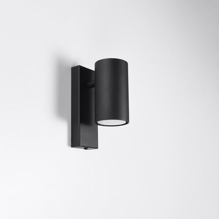 Applique murale noire cylindrique fixée sur un mur clair, ligne épurée et graphique