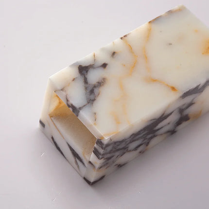Détail du bloc de marbre naturel de l'applique posé à plat, veinures grises et filets dorés uniques