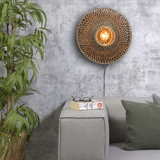 Detail of the graphic black and natural weave of the Bali wall light, diffused light in the center