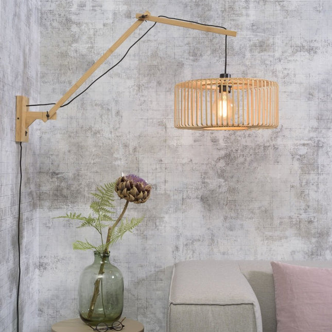 Bromo natural bamboo wall light with unfolded arm above a sofa, Japandi living room atmosphere