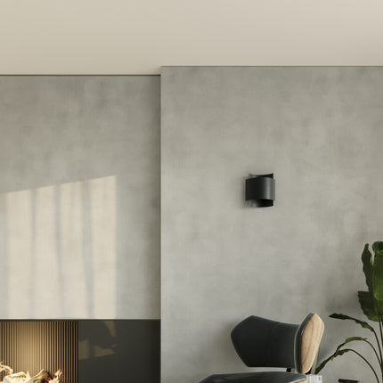 Applique murale acier noir sur mur en beton cire dans un salon contemporain