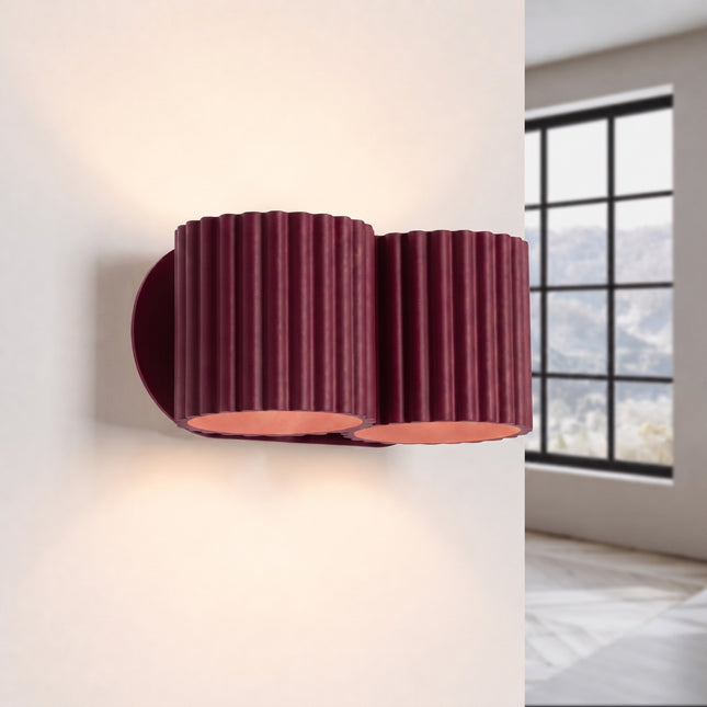 Double Aura wall light in burgundy, lit, four beams up and down