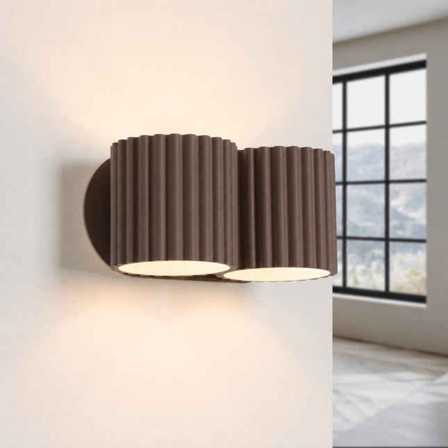 Double Aura wall light in chocolate brown, lit, four beams up and down