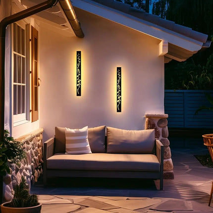 Deux appliques murales extérieures noires LED éclairant une terrasse avec banquette au soir