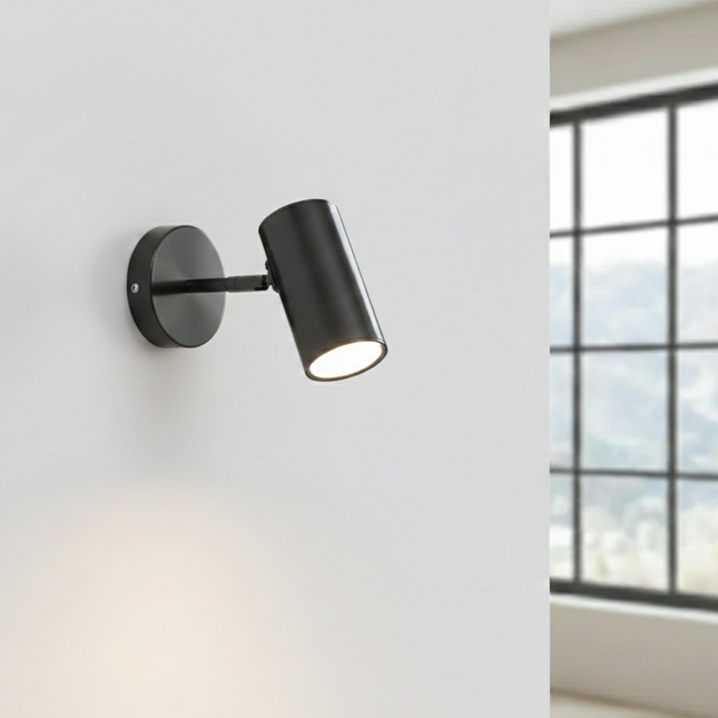 Applique murale LED nordique réglable noire sur un mur clair
