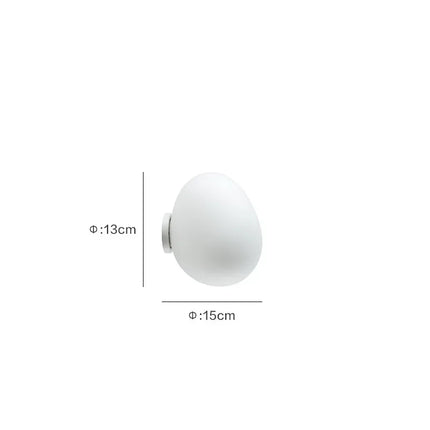 Applique murale LED sphérique diamètre 13 cm au-dessus d'un chevet