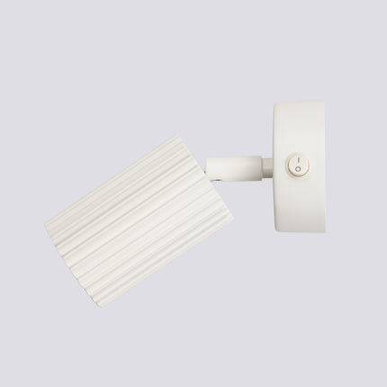 Applique murale orientable Oslo avec interrupteur beige, vue sur fond coloré