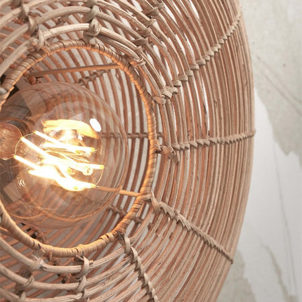 Close-up of the heart of the Tanami wall light, E27 bulb encircled by the natural rattan weave