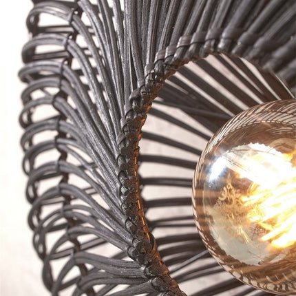 Detail of the handcrafted weave of the black rattan strands forming the lampshade of the Zanzibar wall light