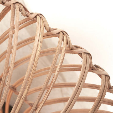 Close-up of the handcrafted natural rattan weave of the Zanzibar wall light
