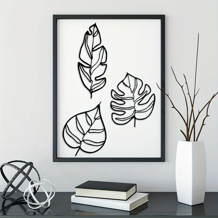 Feuilles murales en métal noir ligne épurée sur un mur clair au-dessus d'une console épurée
