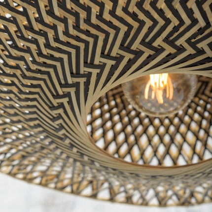 Vue intérieure de l'abat-jour tressé du lampadaire Bali laissant filtrer la lumière de l'ampoule