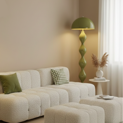 Lampadaire champignon vert olive allumé près d'un canapé bouclette dans un salon beige