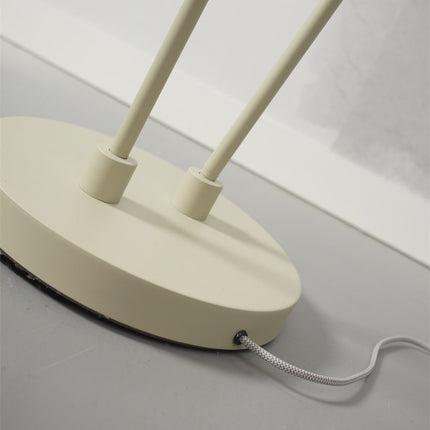 Detail of the oval sand iron base with the two rods and the grey and white textile cable