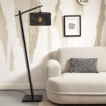 Vue d'ensemble du lampadaire Java, silhouette élancée noire et abat-jour en bambou tressé, posé au sol d'un salon clair