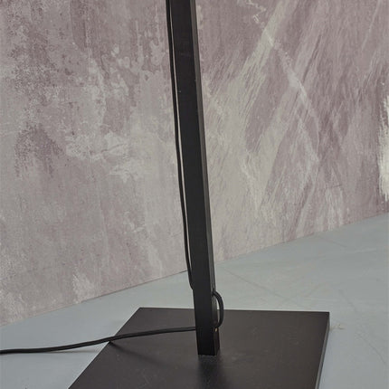 Détail de la base carrée noire et stable du lampadaire Java, avec le câble textile qui s'en échappe