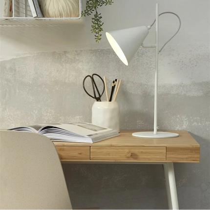 Lit white Lisbon table lamp, soft light diffused on a desk