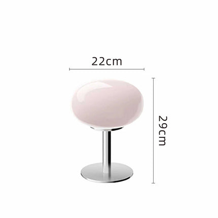 Lampe de chevet sucette nordique rose sur une table de nuit