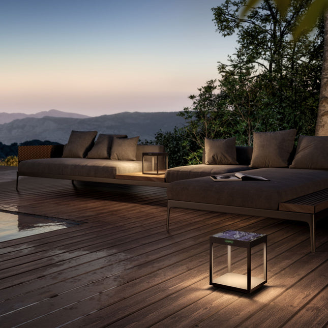 Lampe solaire Klewe Radia posée sur une terrasse en bois au coucher du soleil, ambiance chaleureuse
