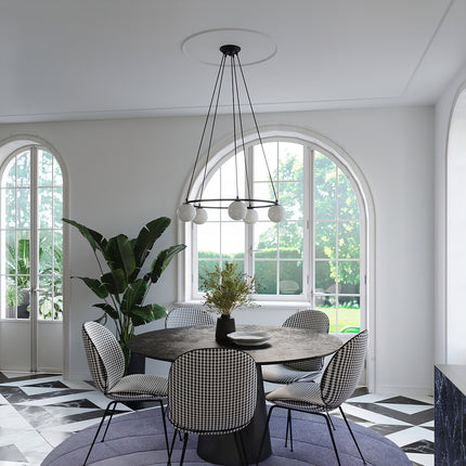 Lustre Globe Solis 3 au-dessus d'une table à manger ronde, décor contemporain graphique