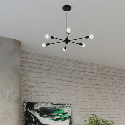 Lustre Satellite 5 noir suspendu dans un salon au style industriel, mur de brique et grande baie vitrée
