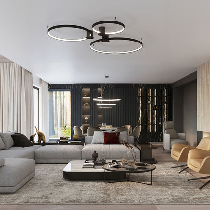 Plafonnier Anneau Solis noir allumé au plafond, halo LED dans un salon moderne