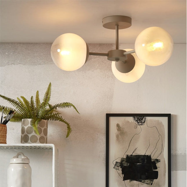 Plafonnier Aspen blanc lait allume au plafond d'un salon scandinave