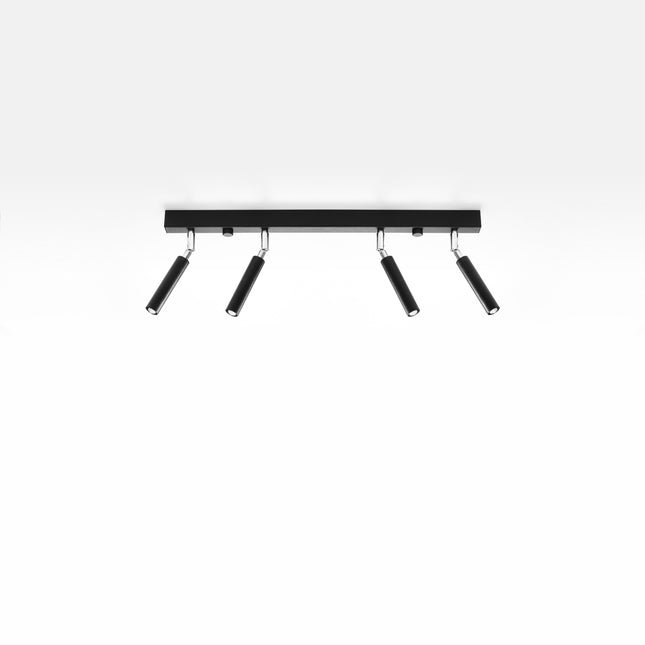 Plafonnier barre 4 spots acier noir vu de trois quarts sur fond clair