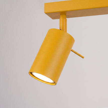 Plafonnier Barre 4 Spots Orientables Jaune Ambré, vue sur fond coloré