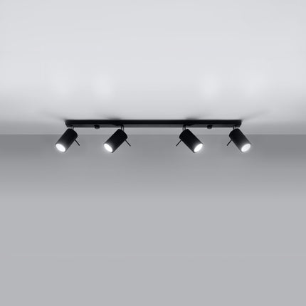 Plafonnier barre 4 spots orientables noir au-dessus d'un plan de travail