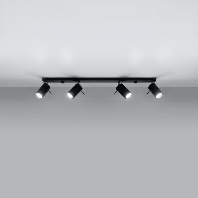 Plafonnier barre 4 spots orientables noir au-dessus d'un plan de travail