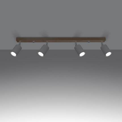 Gros plan sur un spot orientable en acier blanc fixé à la barre en bois massif