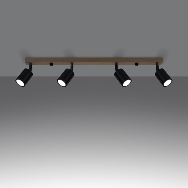 Gros plan sur un spot orientable en acier noir fixé à la barre en bois massif