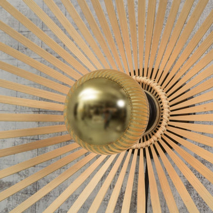 Close-up of the E27 base and the woven bamboo structure of the Bromo ceiling light, golden ambiance