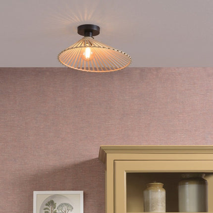 Bromo ceiling light in braided natural bamboo hanging on the ceiling, warm light diffused in a living room with pink tones