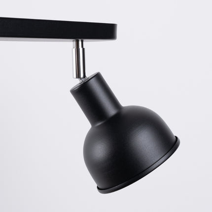 Gros plan sur les cloches orientables noires du plafonnier Elba