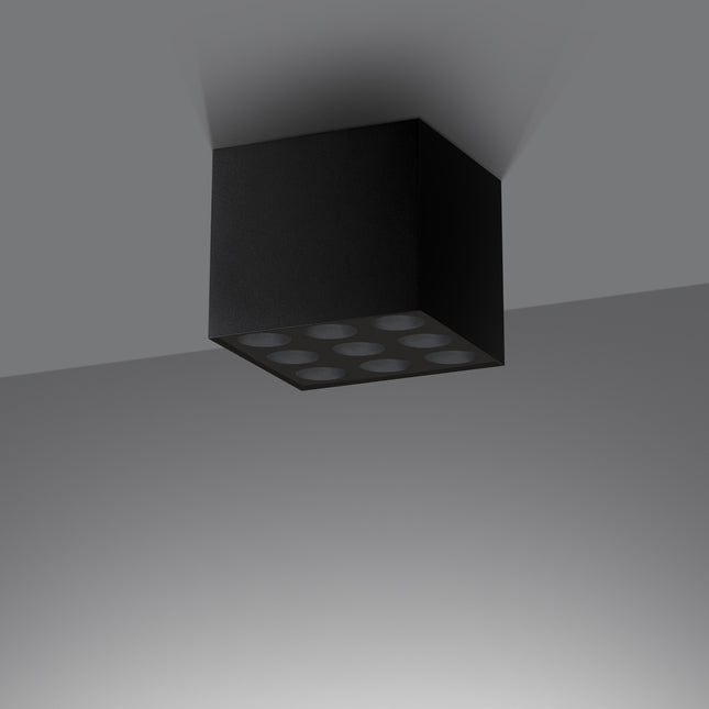 Plafonnier cube noir vu de trois quarts, fini aluminium mat et arêtes nettes